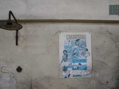 Sul muro si nota un poster del calciatore Ruud Gullit